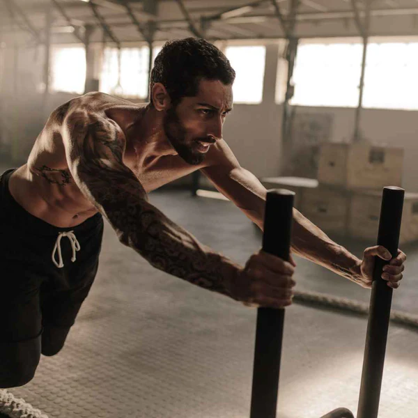 Man pushing sled in gym,Fat_Burn_HIIT_Workout